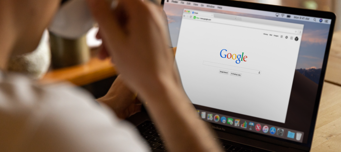 A person drinking coffee while browsing Google on a MacBook Pro, highlighting the risk when startups ignore digital marketing.